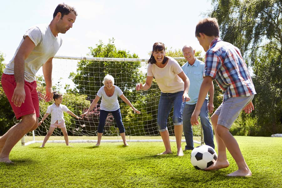 Family playing football on Trend Artificial Grass